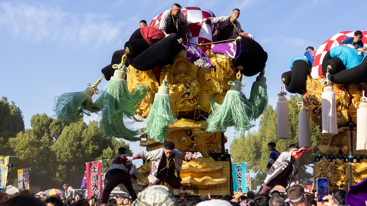 Dynamic scene of performers atop taiko floats